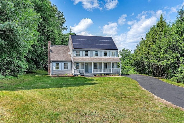 69 Biscuit Hill Dr, Leominster, MA 01453 - colonial house featuring covered porch, roof mounted solar panels, a front yard, and asphalt driveway