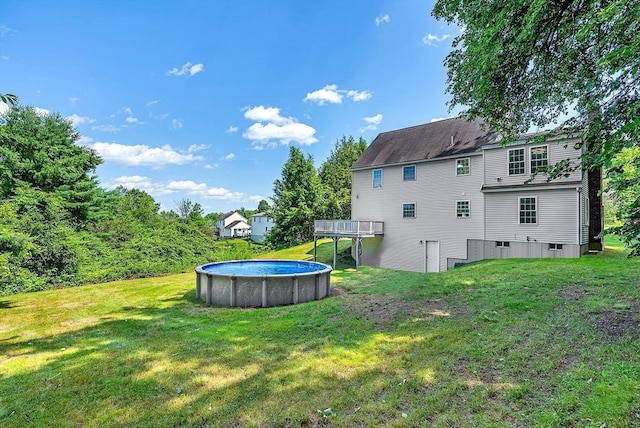 69 Biscuit Hill Dr, Leominster, MA 01453 - back of property featuring a lawn, an outdoor pool, and a deck