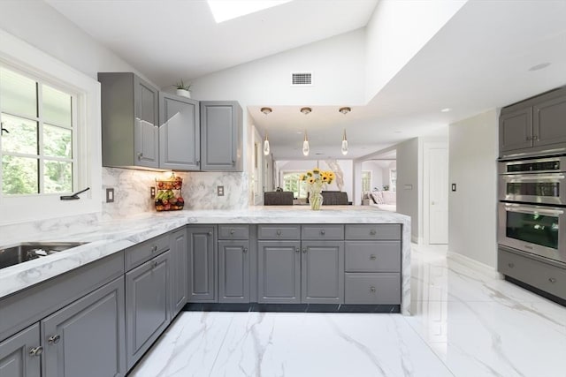 338 Highland St, Weston, MA 02493 - kitchen featuring gray cabinets, stainless steel double oven, light marble finish flooring, a peninsula, and backsplash
