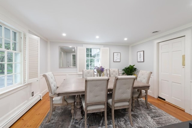 338 Highland St, Weston, MA 02493 - dining space featuring a baseboard heating unit, light wood-type flooring, recessed lighting, wainscoting, and crown molding