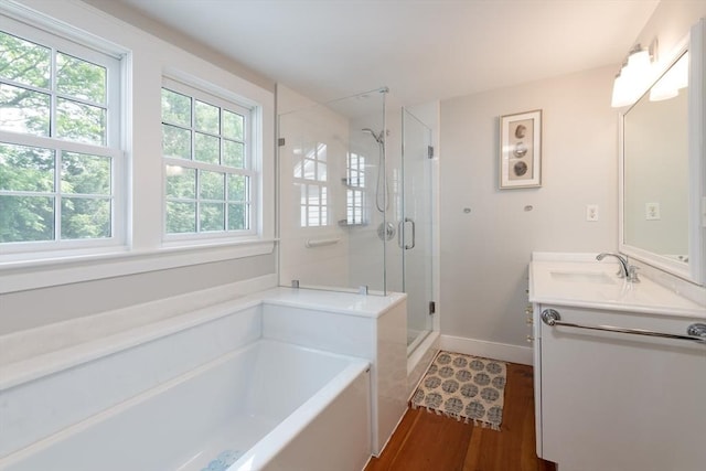 338 Highland St, Weston, MA 02493 - bathroom featuring a garden tub, a shower stall, vanity, wood finished floors, and baseboards