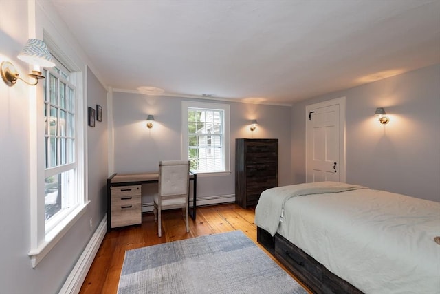 338 Highland St, Weston, MA 02493 - bedroom with baseboard heating, wood-type flooring, a desk, and baseboards