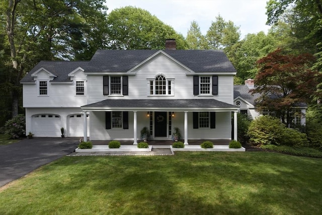 338 Highland St, Weston, MA 02493 - view of front of property featuring driveway, covered porch, an attached garage, a chimney, and a front yard