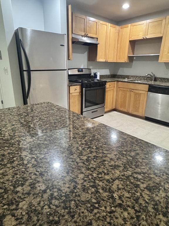 486 Revere Unit 2, Revere, MA 02151 - kitchen with stainless steel appliances, under cabinet range hood, dark stone countertops, recessed lighting, and light tile patterned floors
