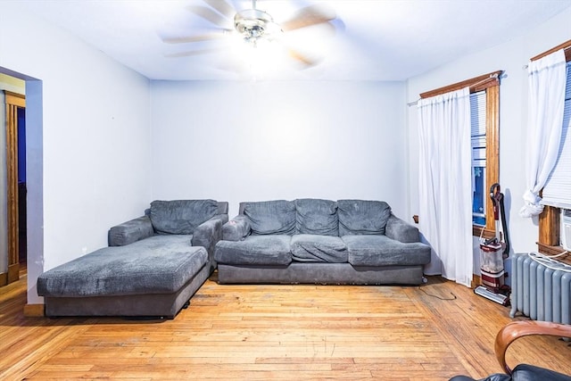 living room with ceiling fan, radiator heating unit, and light wood-type flooring