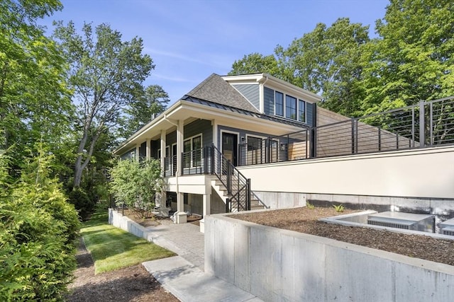 145 Warren St Unit 5, Newton, MA 02459 - view of front facade with stairway, a standing seam roof, and a metal roof