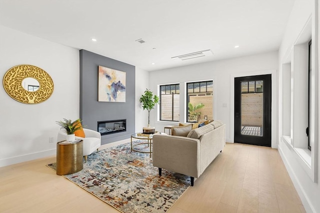 145 Warren St Unit 5, Newton, MA 02459 - living room featuring light wood-style floors, a glass covered fireplace, and recessed lighting