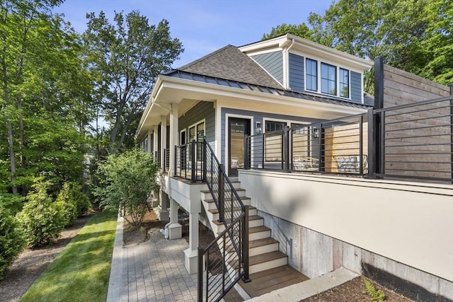 145 Warren St Unit 5, Newton, MA 02459 - view of side of property with a standing seam roof, a shingled roof, stairs, a metal roof, and covered porch