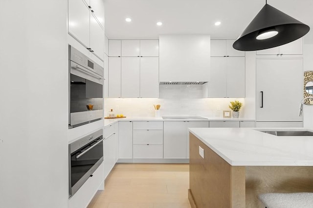 145 Warren St Unit 5, Newton, MA 02459 - kitchen featuring premium range hood, stainless steel oven, modern cabinets, and recessed lighting