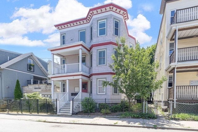 41 Sudan St Unit 3, Boston, MA 02125 - view of front of property with a balcony, a fenced front yard, covered porch, and a gate