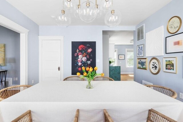 41 Sudan St Unit 3, Boston, MA 02125 - dining area featuring a chandelier and wood finished floors
