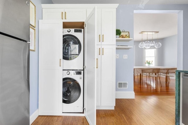 41 Sudan St Unit 3, Boston, MA 02125 - laundry room featuring stacked washer / drying machine and wood finished floors