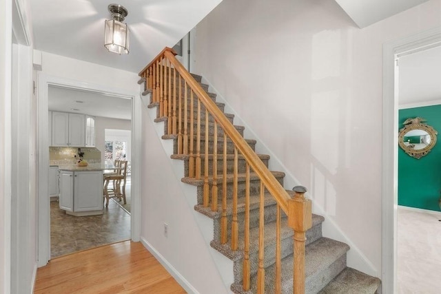 stairway with hardwood / wood-style flooring