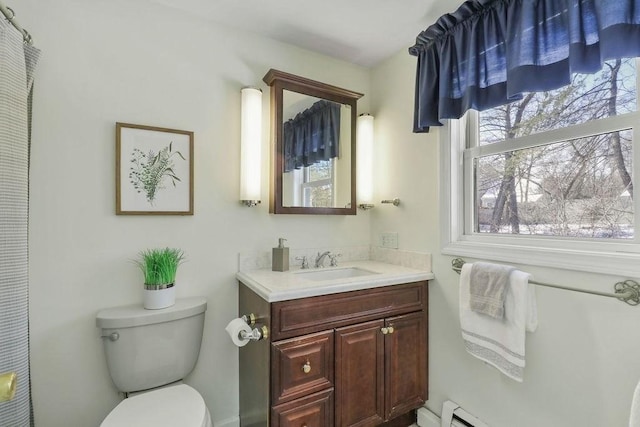 bathroom featuring baseboard heating, vanity, and toilet