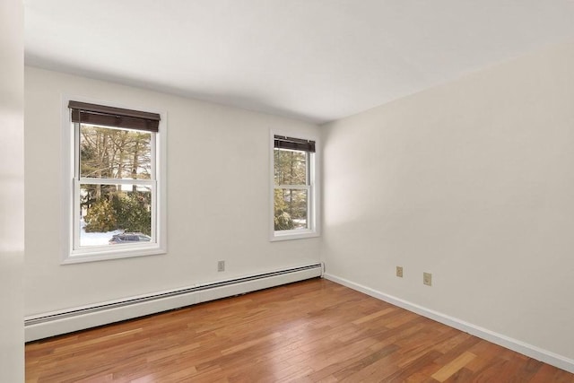 spare room featuring light hardwood / wood-style floors and baseboard heating