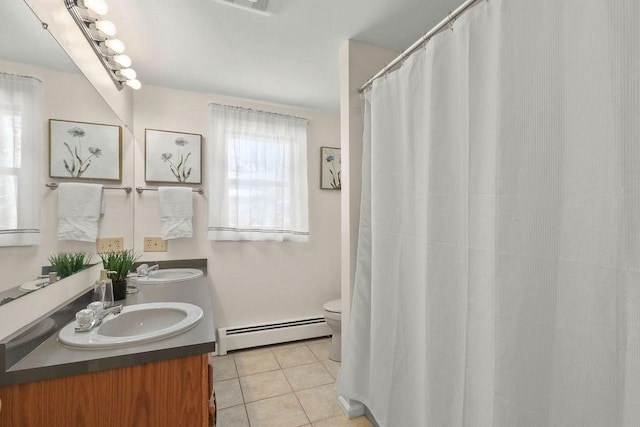 bathroom featuring tile patterned flooring, vanity, a baseboard heating unit, and toilet