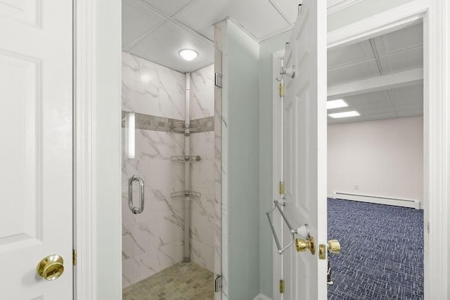 bathroom with a baseboard heating unit and a shower with shower door