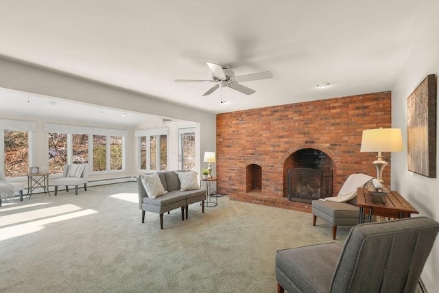 living room with ceiling fan, light colored carpet, baseboard heating, and a brick fireplace