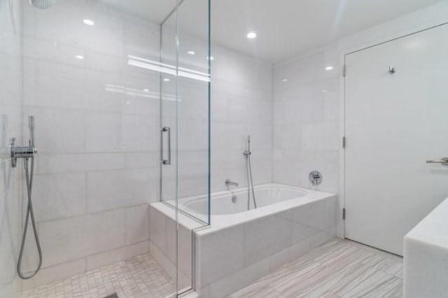 full bathroom with a stall shower and a garden tub