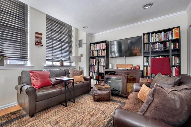 sitting room with crown molding and hardwood / wood-style floors