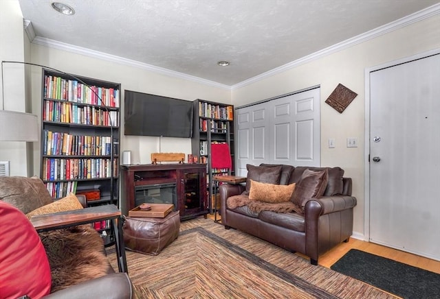 living area with ornamental molding and hardwood / wood-style flooring