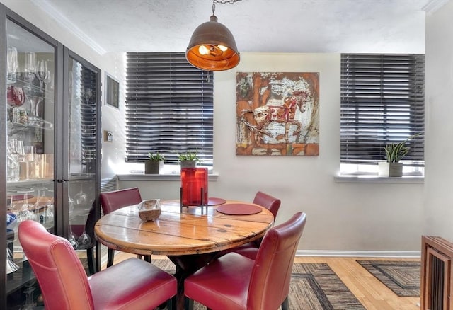 dining room featuring hardwood / wood-style flooring and ornamental molding