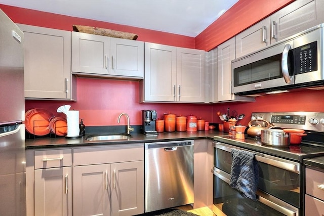 kitchen with sink, stainless steel appliances, and white cabinetry