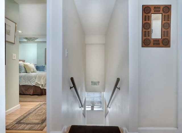 stairway with hardwood / wood-style flooring