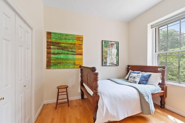 60 Glen Rd Unit 107, Brookline, MA 02445 - bedroom with light wood-style floors, baseboards, and a closet