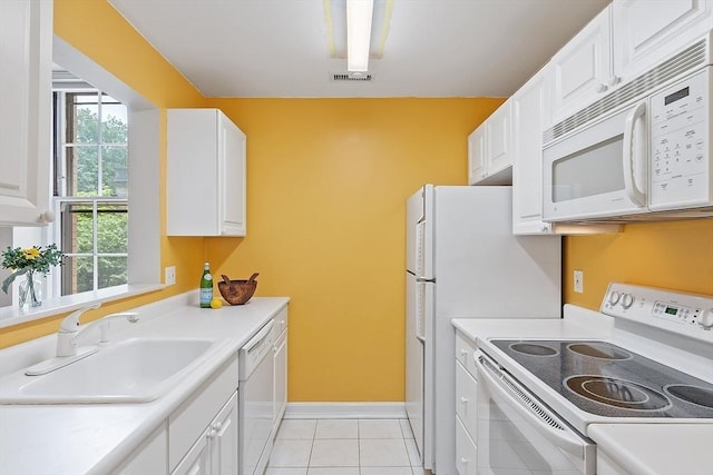60 Glen Rd Unit 107, Brookline, MA 02445 - kitchen featuring white appliances, a sink, white cabinets, and light countertops