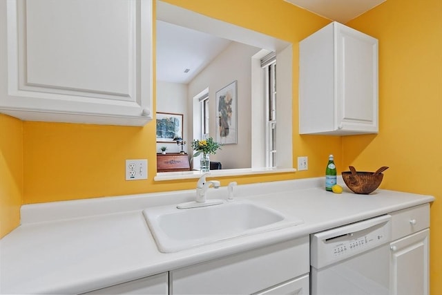 60 Glen Rd Unit 107, Brookline, MA 02445 - kitchen with white dishwasher, a sink, white cabinets, and light countertops