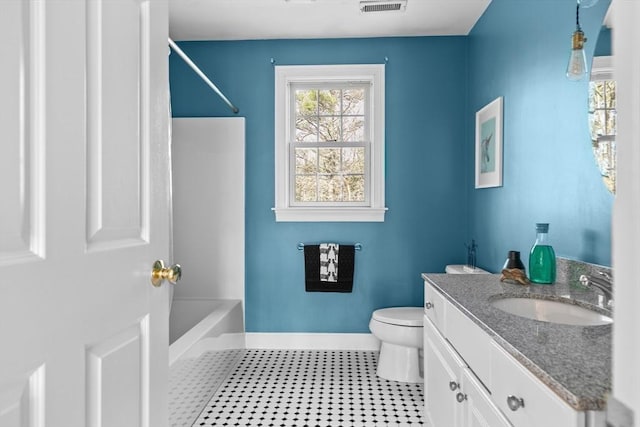 bathroom with vanity, visible vents, baseboards,  shower combination, and toilet