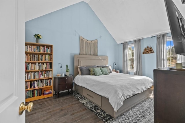 bedroom with vaulted ceiling and wood finished floors