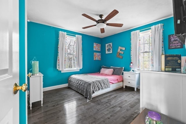 bedroom with a ceiling fan, baseboards, and wood finished floors