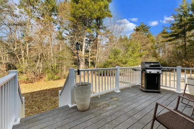 wooden deck with a grill