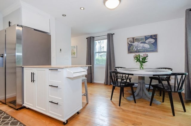 300 Falmouth Rd Unit 12A, Mashpee, MA 02649 - kitchen featuring white cabinets, light wood-style floors, light countertops, stainless steel refrigerator with ice dispenser, and a kitchen breakfast bar