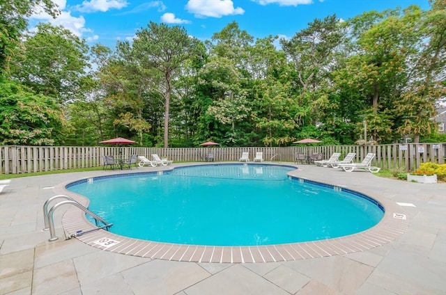 300 Falmouth Rd Unit 12A, Mashpee, MA 02649 - community pool featuring a patio, a fenced backyard, and view of wooded area