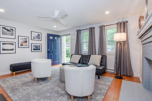 300 Falmouth Rd Unit 12A, Mashpee, MA 02649 - living area featuring hardwood / wood-style floors, baseboard heating, a fireplace, ceiling fan, and recessed lighting