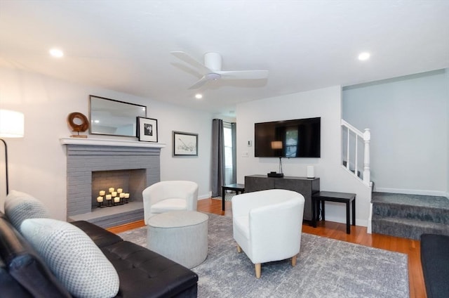 300 Falmouth Rd Unit 12A, Mashpee, MA 02649 - living area featuring stairs, wood finished floors, ceiling fan, a brick fireplace, and recessed lighting