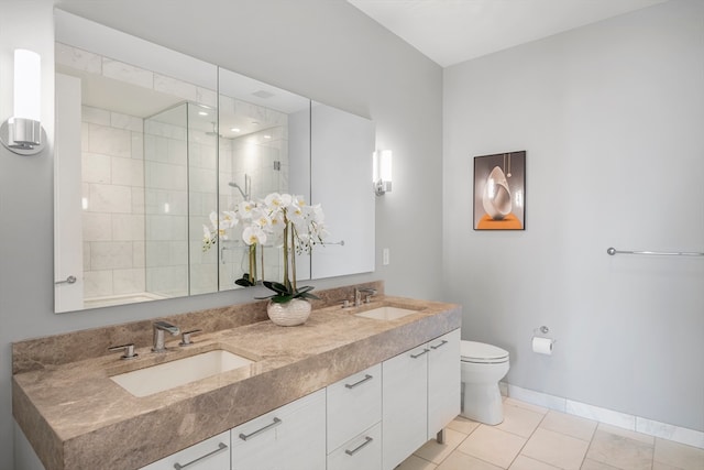 bathroom featuring tiled shower, vanity, toilet, and tile patterned floors