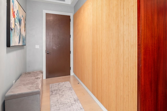 interior space featuring light hardwood / wood-style floors and wood walls