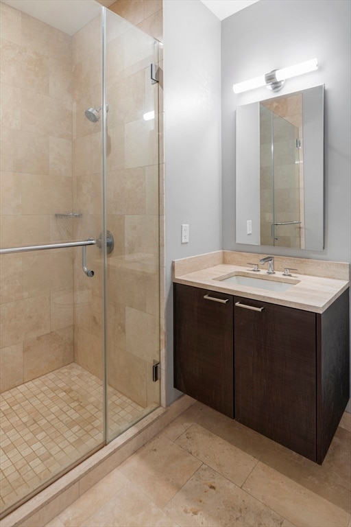 bathroom featuring an enclosed shower and vanity