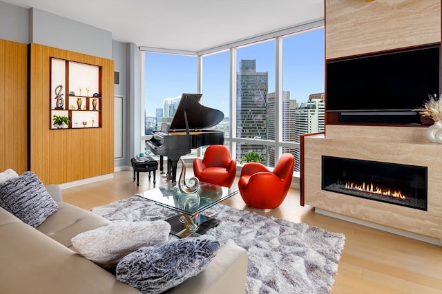 living room featuring light hardwood / wood-style floors, a fireplace, and expansive windows