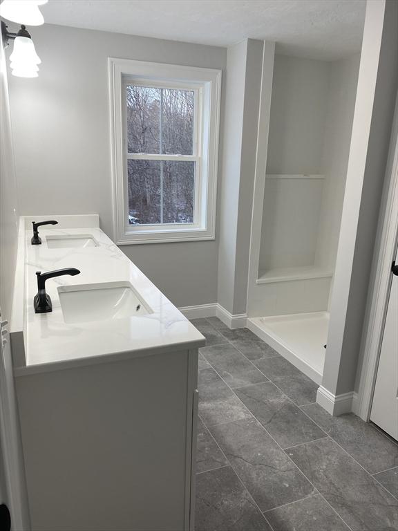 40 Old Summit St, Halifax, MA 02338 - bathroom featuring double vanity, baseboards, and a shower stall