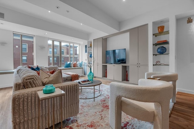 living area with visible vents, built in features, baseboards, light wood-style flooring, and recessed lighting