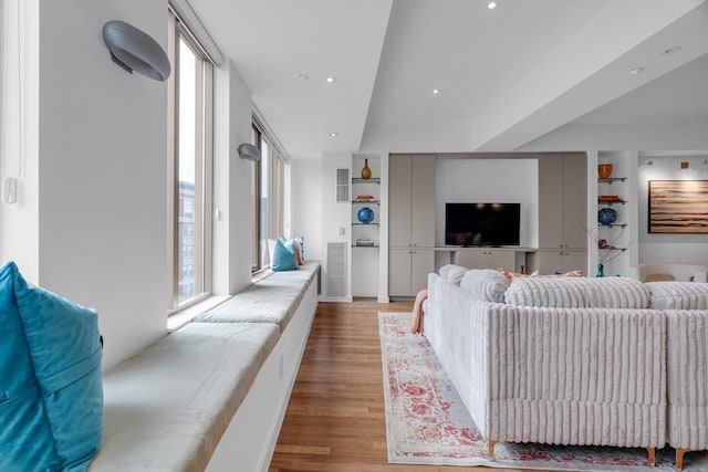 living room with light wood-style floors, recessed lighting, and visible vents