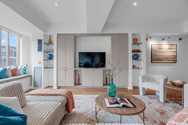 living area with recessed lighting, built in features, visible vents, and light wood-style floors