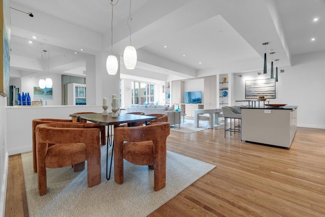 dining room featuring light wood-style flooring, baseboards, and recessed lighting