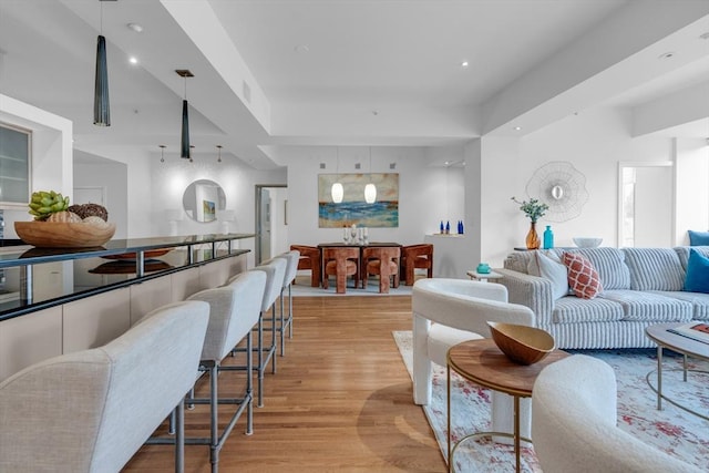 living area with light wood-style floors, recessed lighting, and visible vents