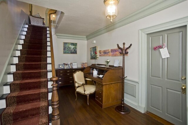 office area with wood finished floors, wainscoting, and ornamental molding